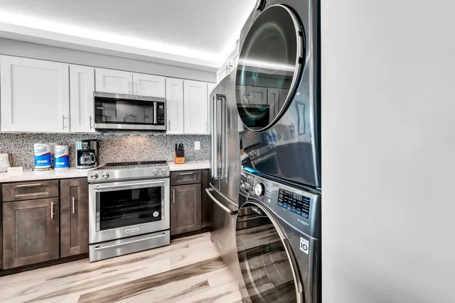 a kitchen with a stove a microwave and a sink