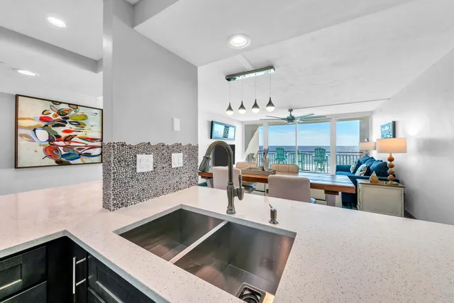 a kitchen with stainless steel appliances a stove a sink and a refrigerator