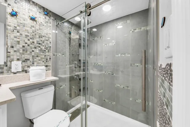 a bathroom with a sink toilet and shower