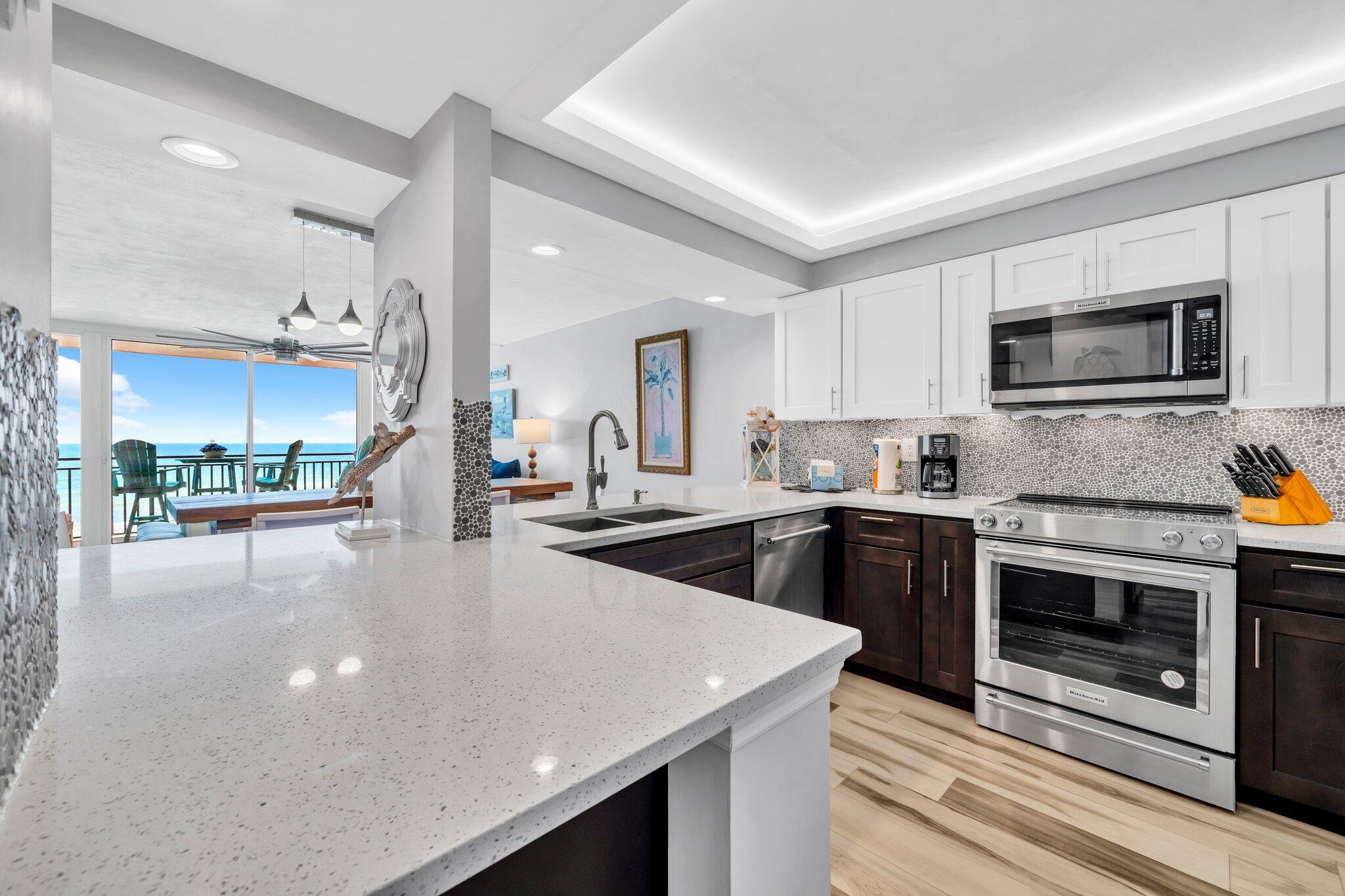 381 Santa Rosa Boulevard, Unit W515 Fort Walton Beach, FL 32548 - Photo 16 of 34 a large kitchen with granite countertop a stove top oven a sink a counter space and cabinets