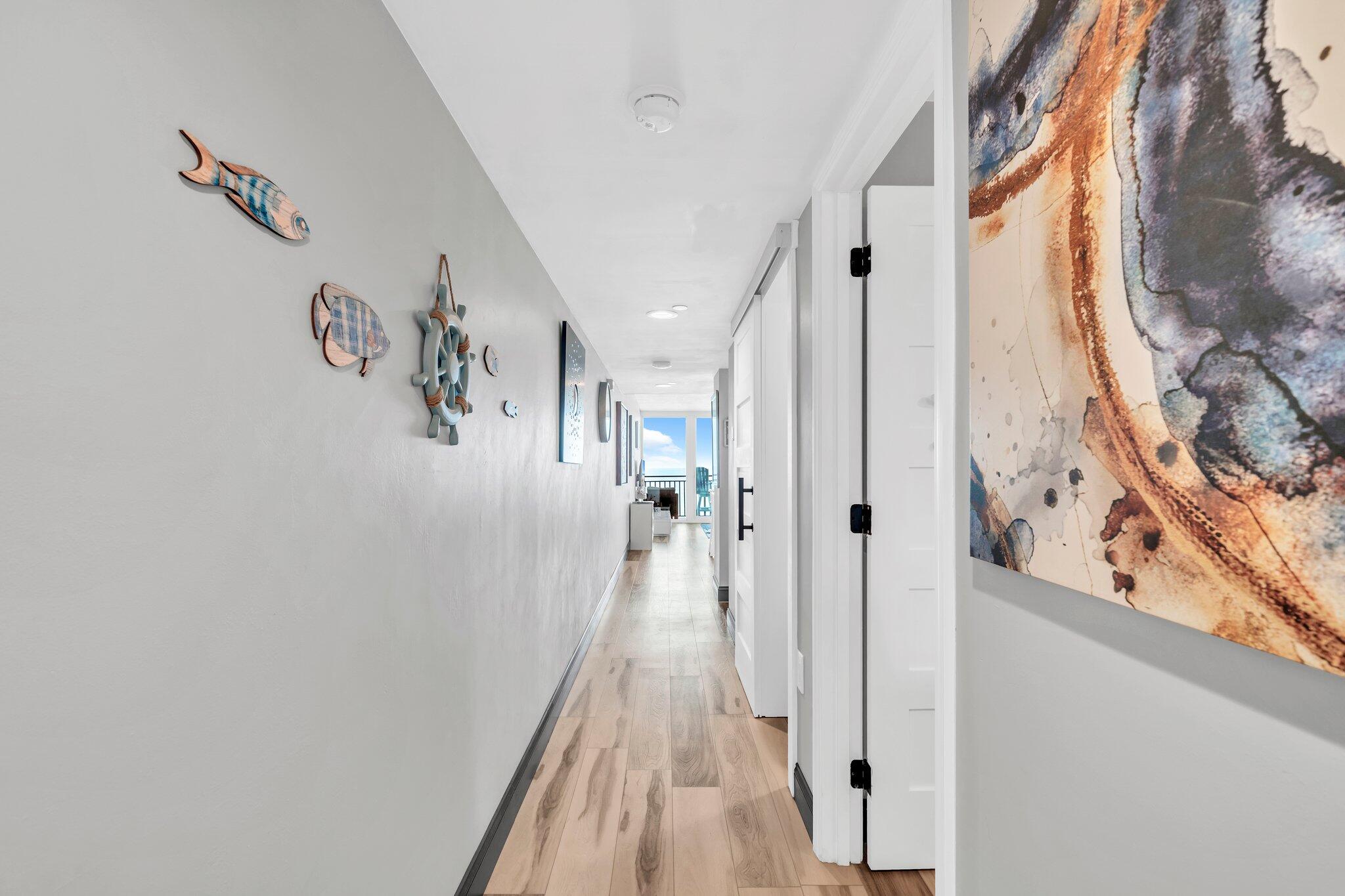 381 Santa Rosa Boulevard, Unit W515 Fort Walton Beach, FL 32548 - Photo 16 of 30 a view of a hallway with wooden floor and staircase
