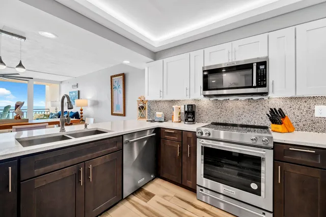 a kitchen with a sink stove and microwave