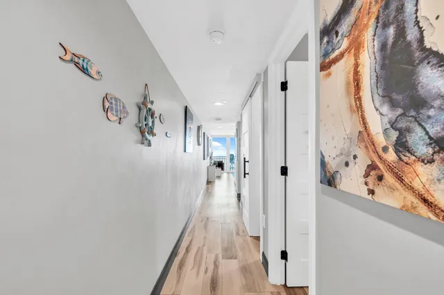 a view of a hallway with wooden floor and staircase