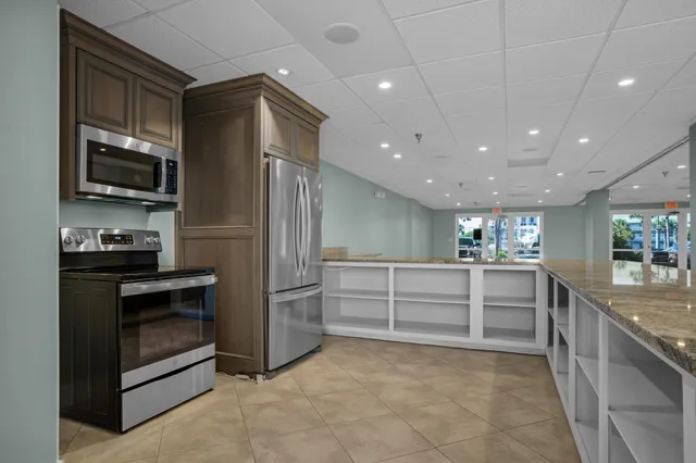a kitchen with cabinets and stainless steel appliances