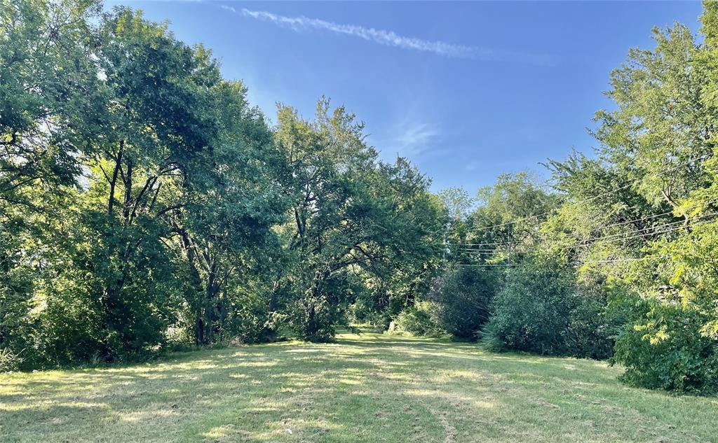 815 Culver Street Commerce, TX 75428 - Photo 2 of 4 a view of outdoor space with trees all around