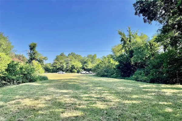 a view of a field with an trees