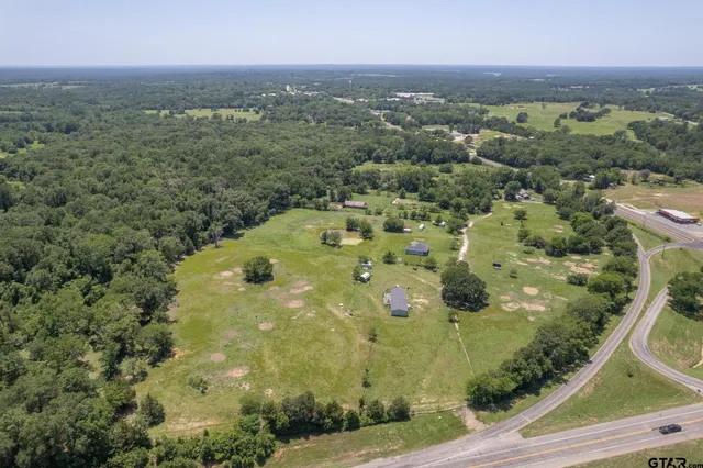 an aerial view of a residential houses with outdoor space