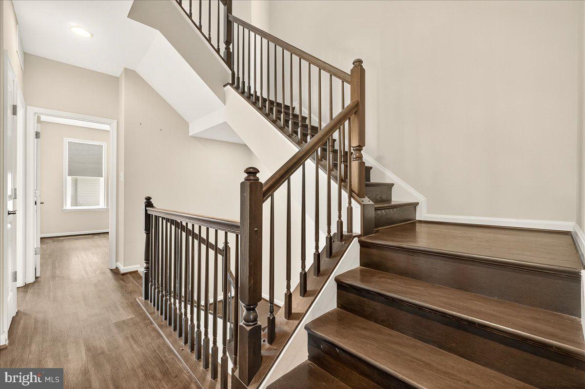 519 Prieur Road Frederick, MD 21701 - Photo 23 of 77 a view of staircase with lots of frames on wall and wooden floor