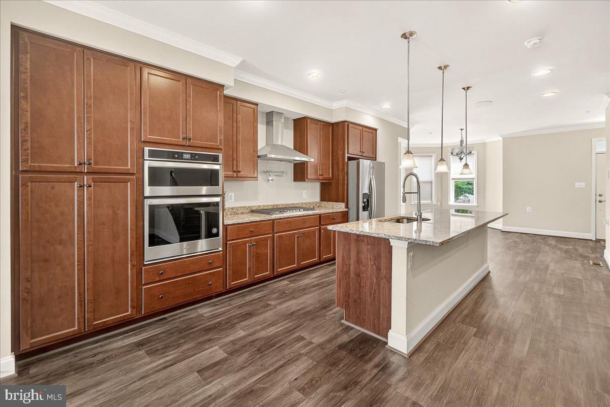 519 Prieur Road Frederick, MD 21701 - Photo 35 of 77 a kitchen with kitchen island wooden cabinets and white appliances