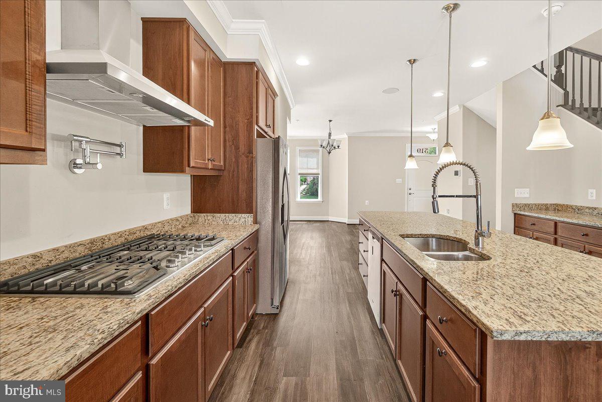 519 Prieur Road Frederick, MD 21701 - Photo 38 of 77 a kitchen with kitchen island stainless steel appliances a stove sink and cabinets