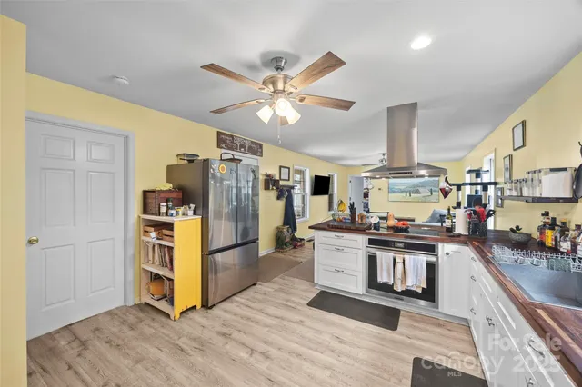 a kitchen with stainless steel appliances a stove a refrigerator and cabinets