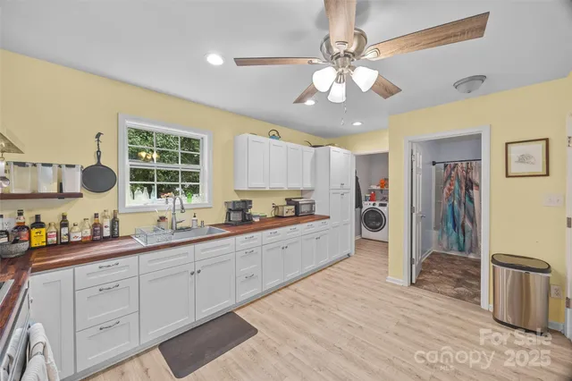 a large kitchen with a large counter space cabinets and stainless steel appliances