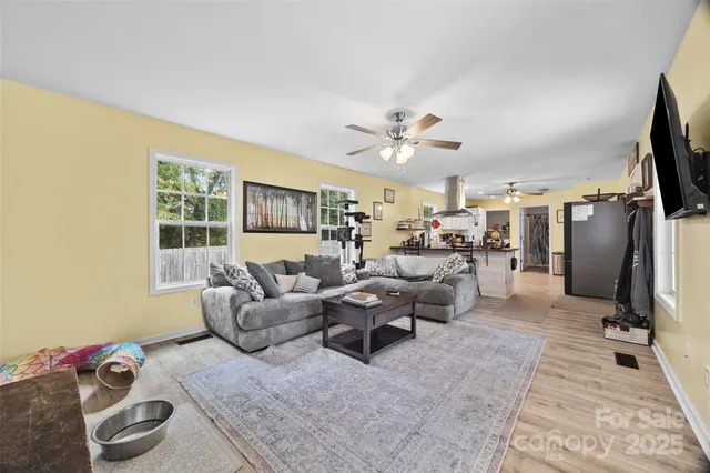 a living room with furniture window and a flat screen tv