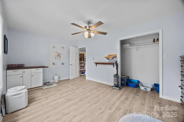 a view of a room with cabinet and a ceiling fan