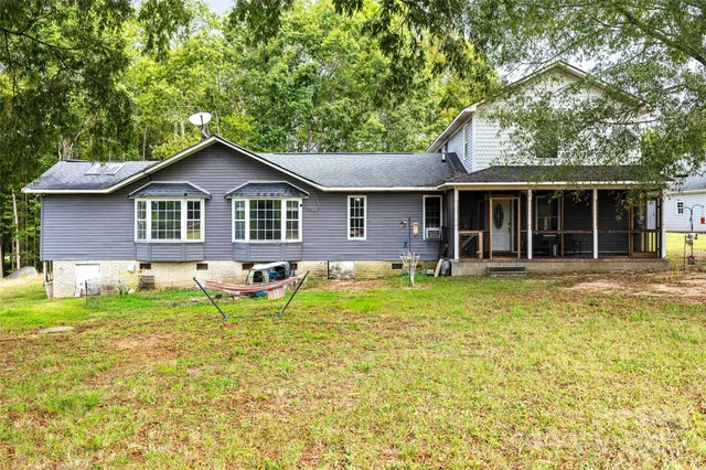 a front view of a house with a yard table and chairs