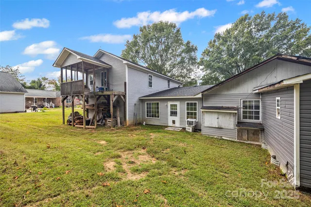 a view of a house with a backyard porch and sitting area