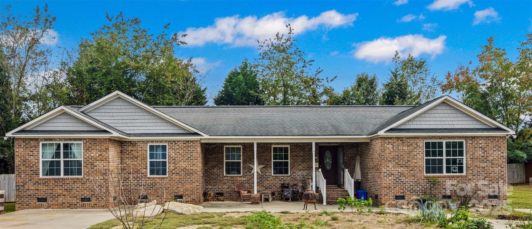 1845 State Rd S-46-149 Clover, SC 29710 - Photo 4 of 48 a front view of a house with garden