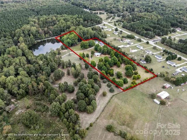 an aerial view of a house with a yard and lake view