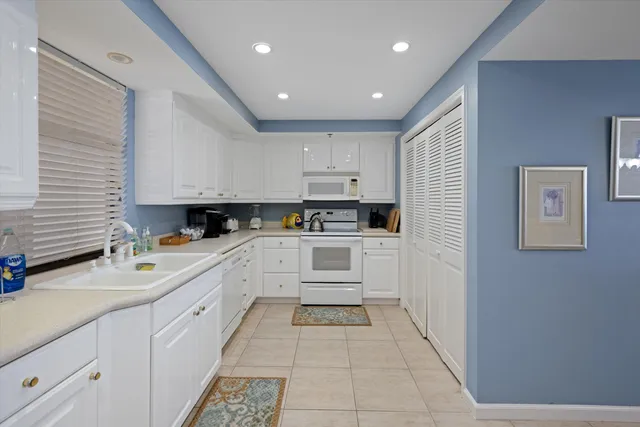 a kitchen with granite countertop a sink and cabinets