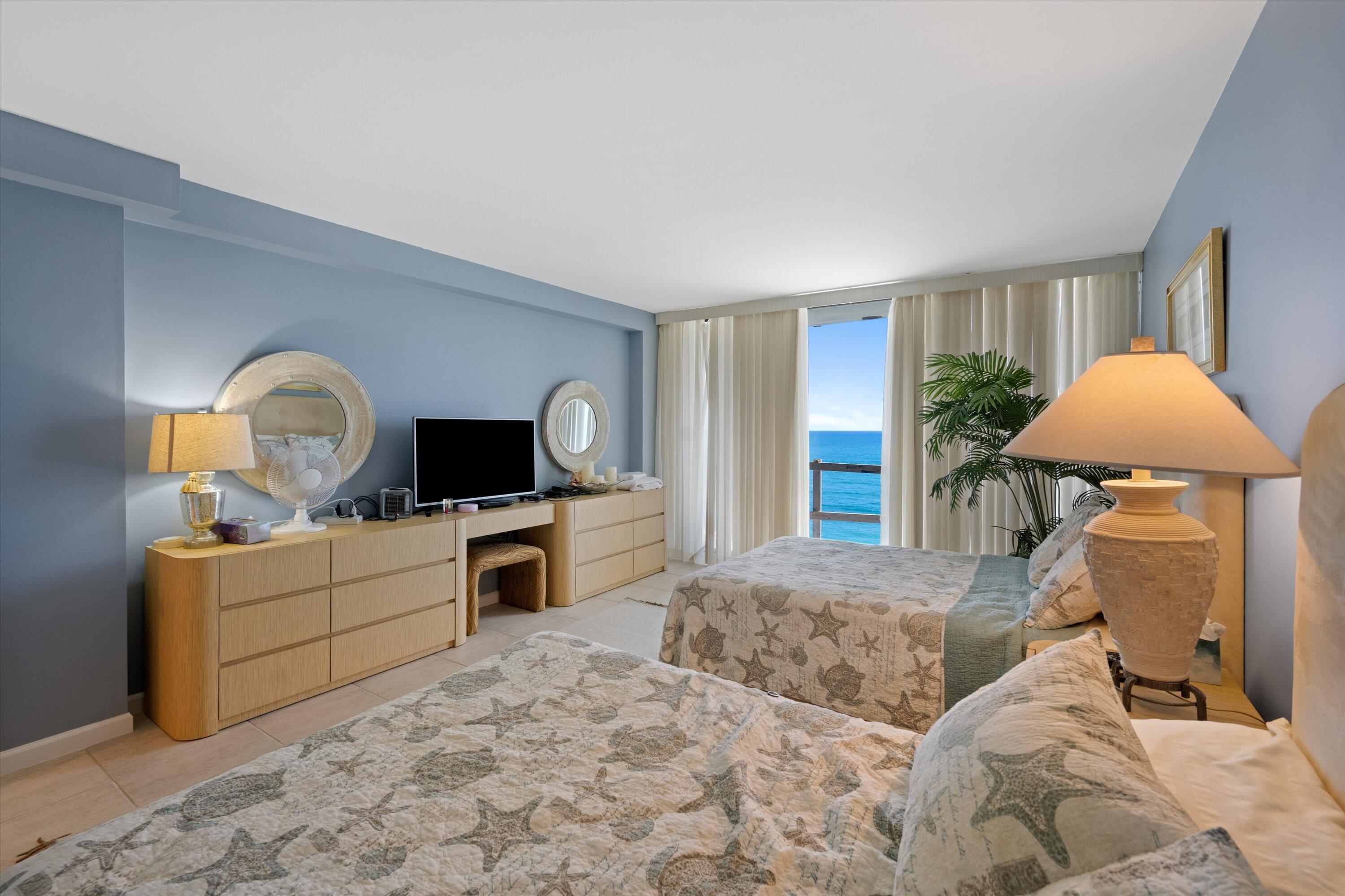 100 South Beach Road, Unit 702 Jupiter, FL 33469 - Photo 14 of 36 a bedroom with a bed and a flat screen tv