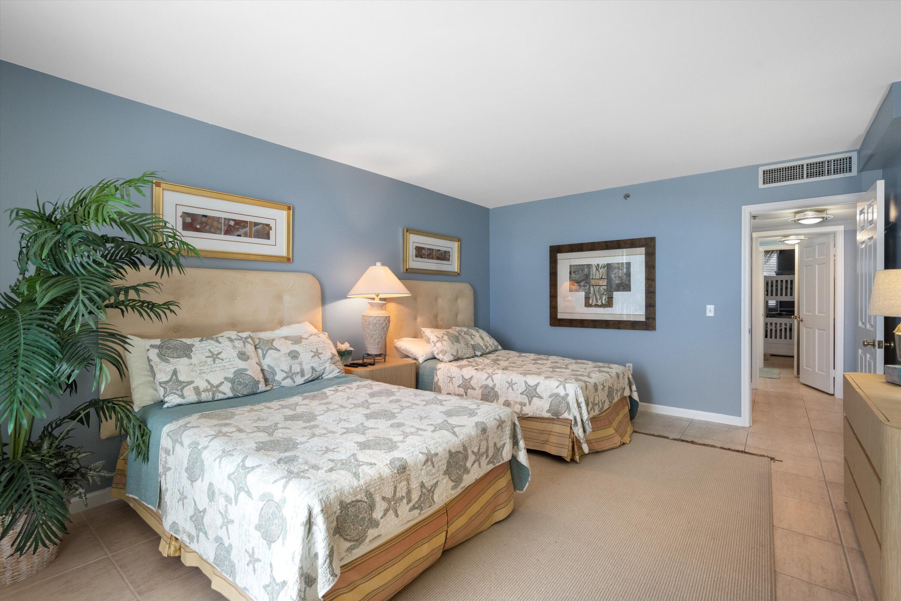 100 South Beach Road, Unit 702 Jupiter, FL 33469 - Photo 16 of 36 a bedroom with two beds and a potted plant