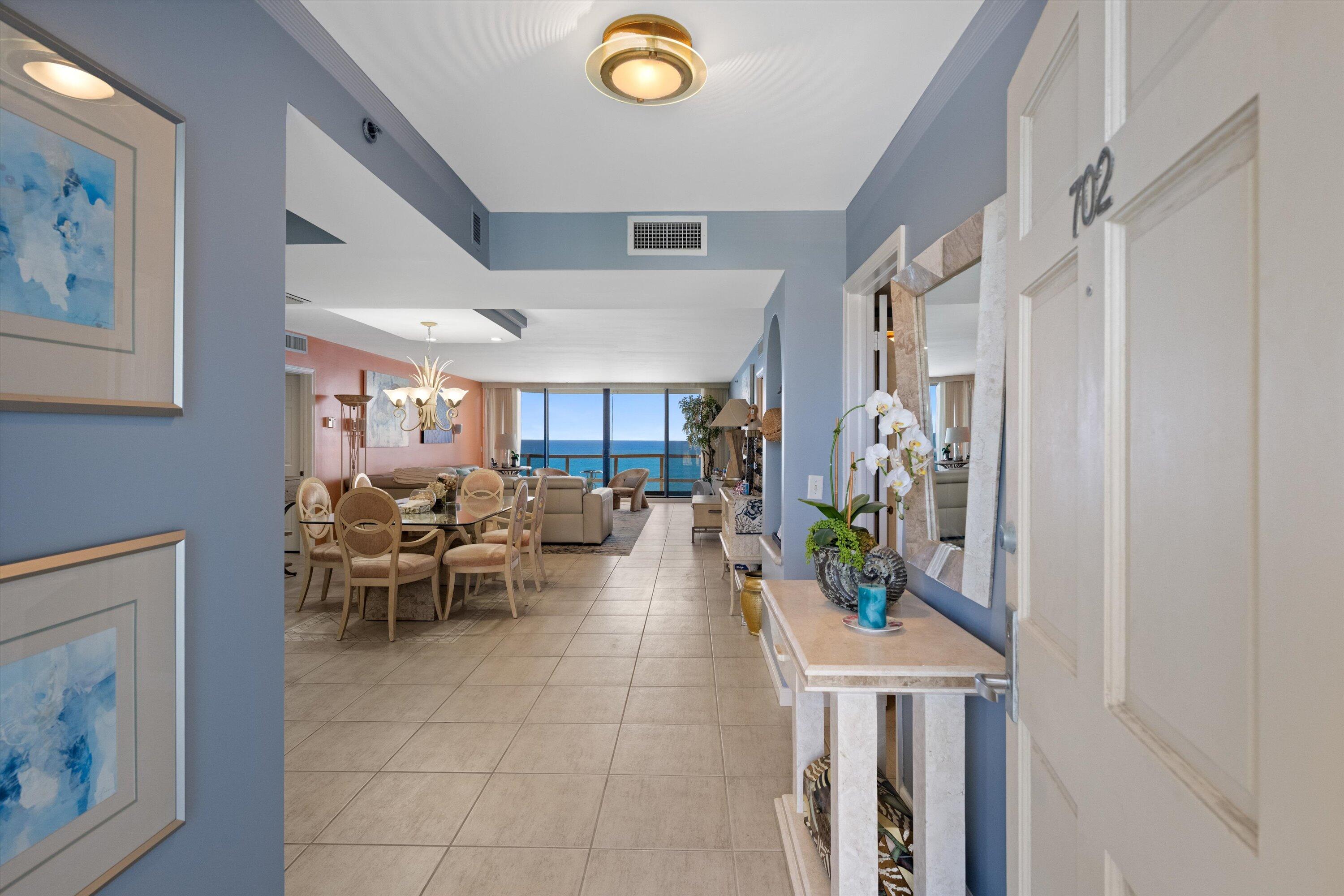 100 South Beach Road, Unit 702 Jupiter, FL 33469 - Photo 2 of 36 a living room with furniture and a potted plant