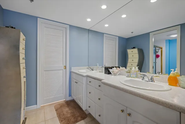 a bathroom with a double vanity sink and a mirror