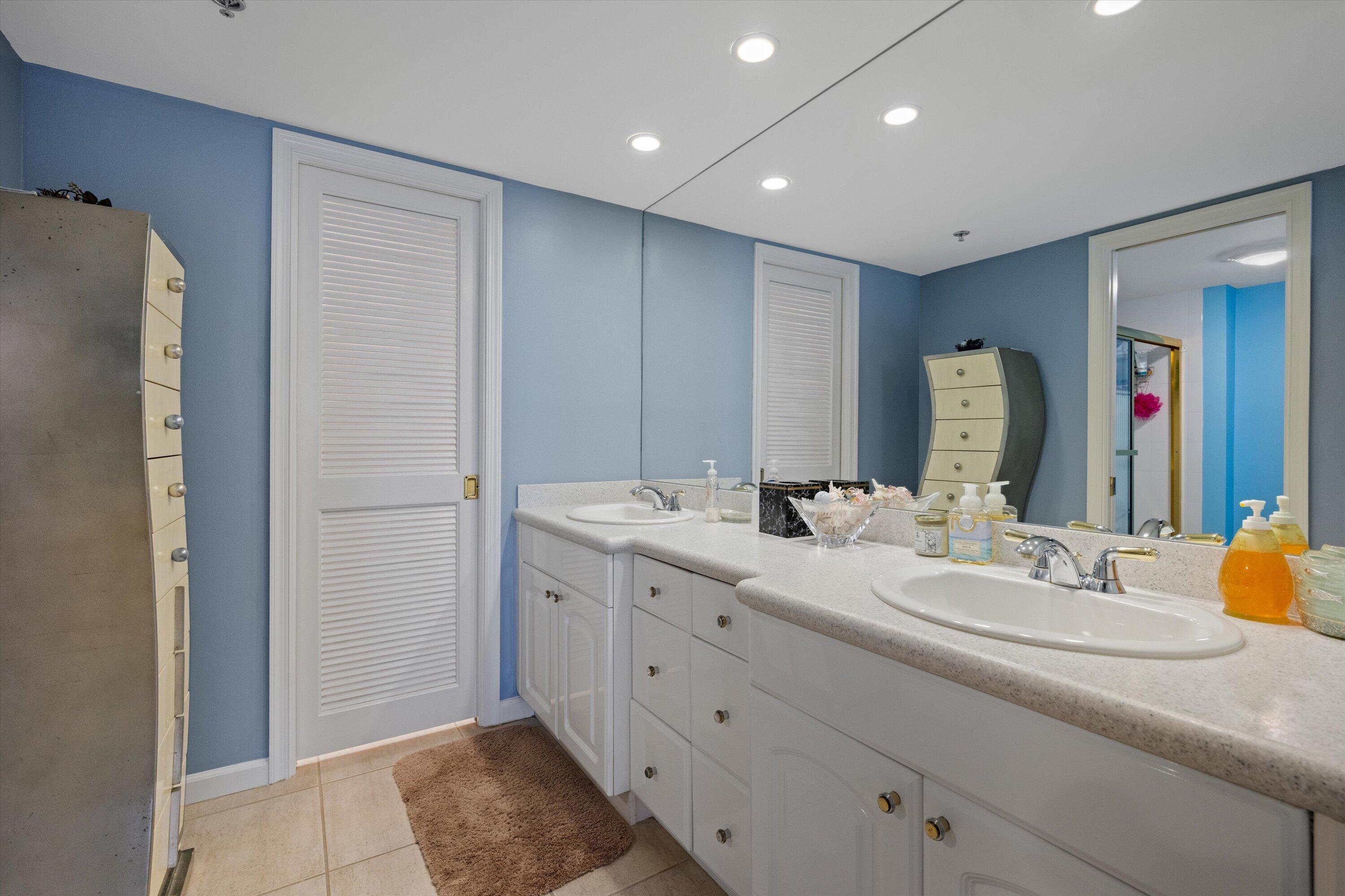 100 South Beach Road, Unit 702 Jupiter, FL 33469 - Photo 22 of 36 a bathroom with a double vanity sink and a mirror