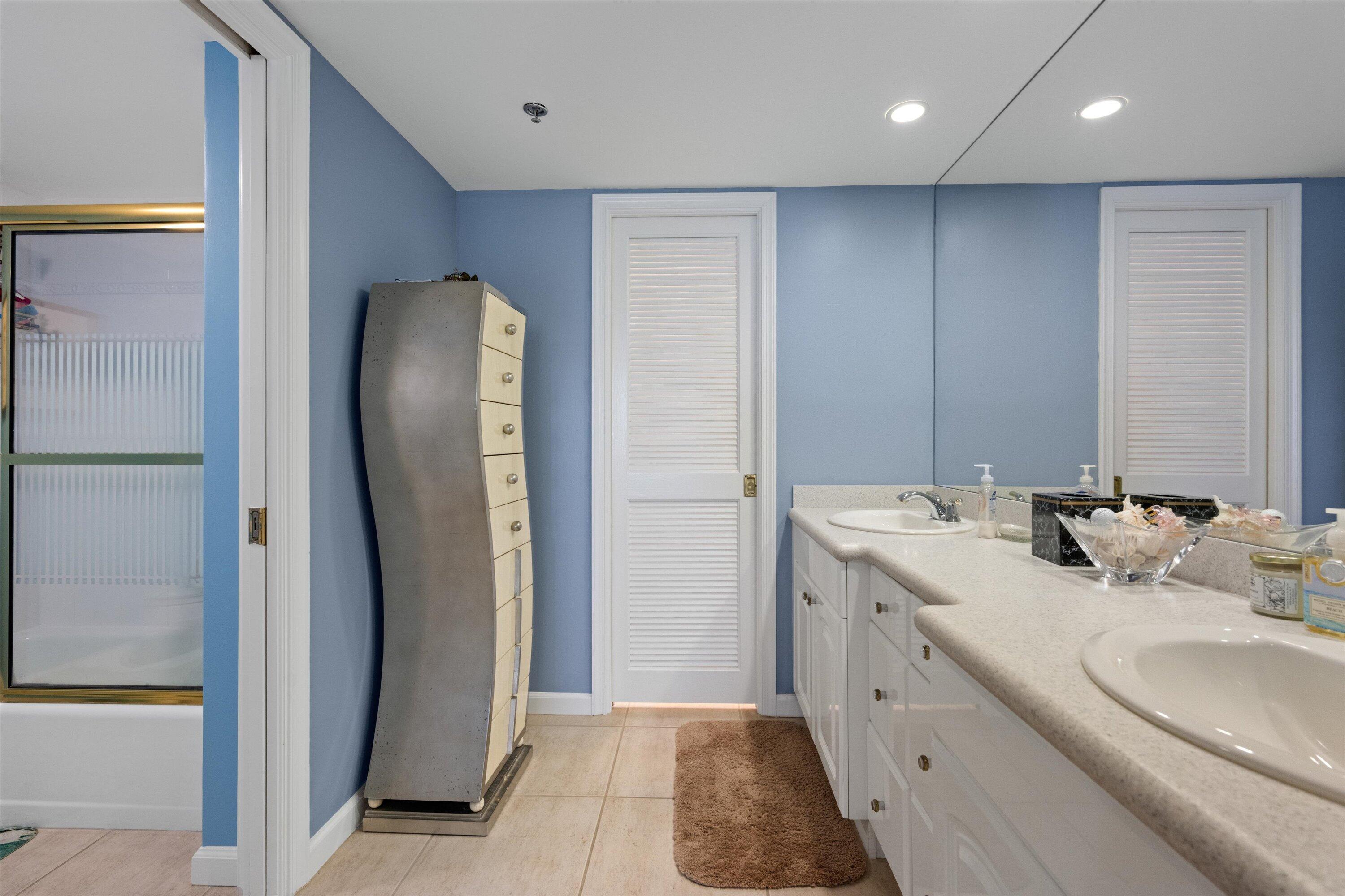 100 South Beach Road, Unit 702 Jupiter, FL 33469 - Photo 23 of 36 a bathroom with a double vanity sink and a mirror