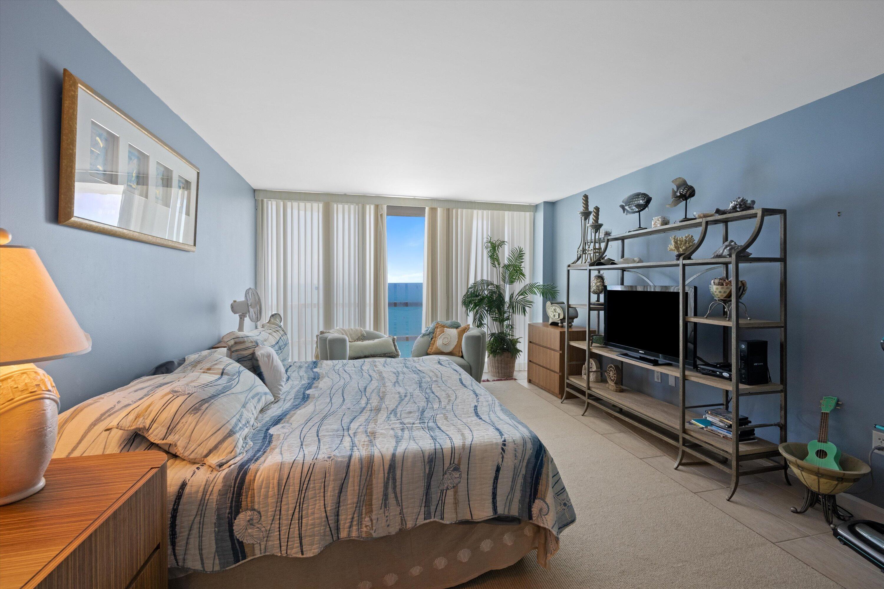 100 South Beach Road, Unit 702 Jupiter, FL 33469 - Photo 25 of 36 a bedroom with two beds and a flat screen tv