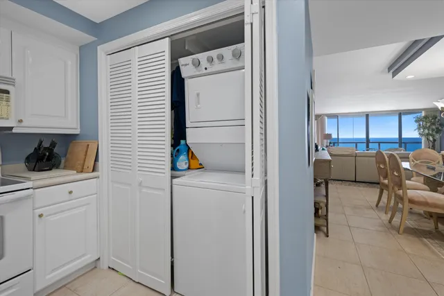 a view of kitchen with furniture and refrigerator