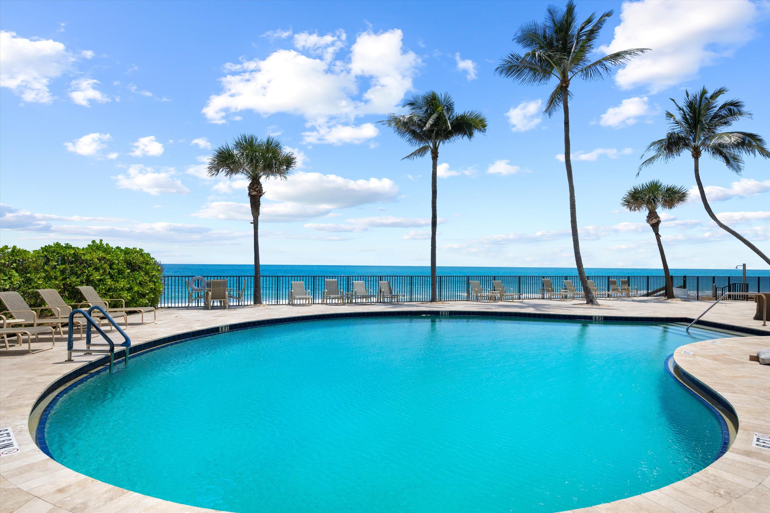 100 South Beach Road, Unit 702 Jupiter, FL 33469 - Photo 35 of 36 a view of a swimming pool with a table and chairs