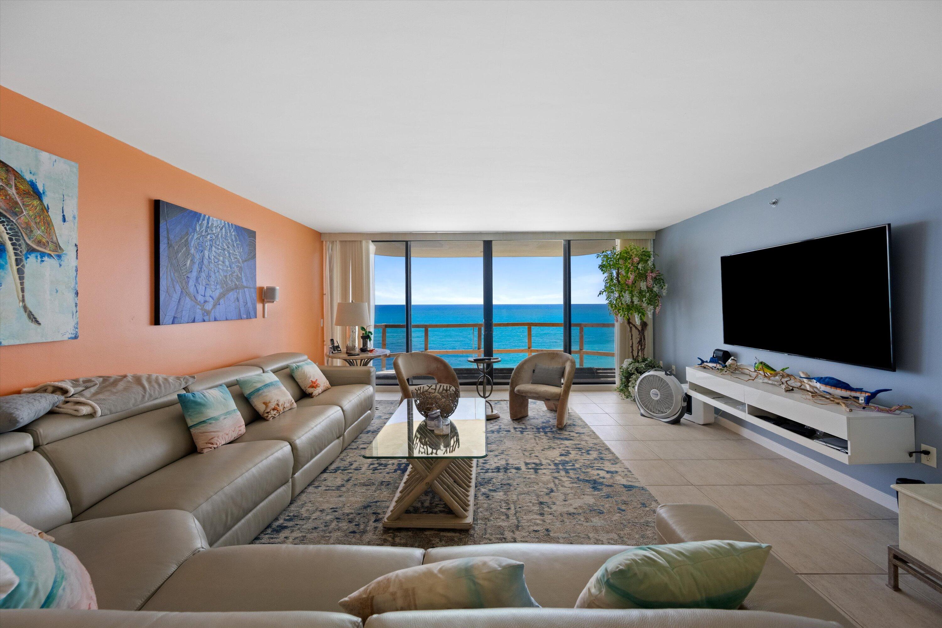 100 South Beach Road, Unit 702 Jupiter, FL 33469 - Photo 7 of 36 a living room with furniture and a flat screen tv