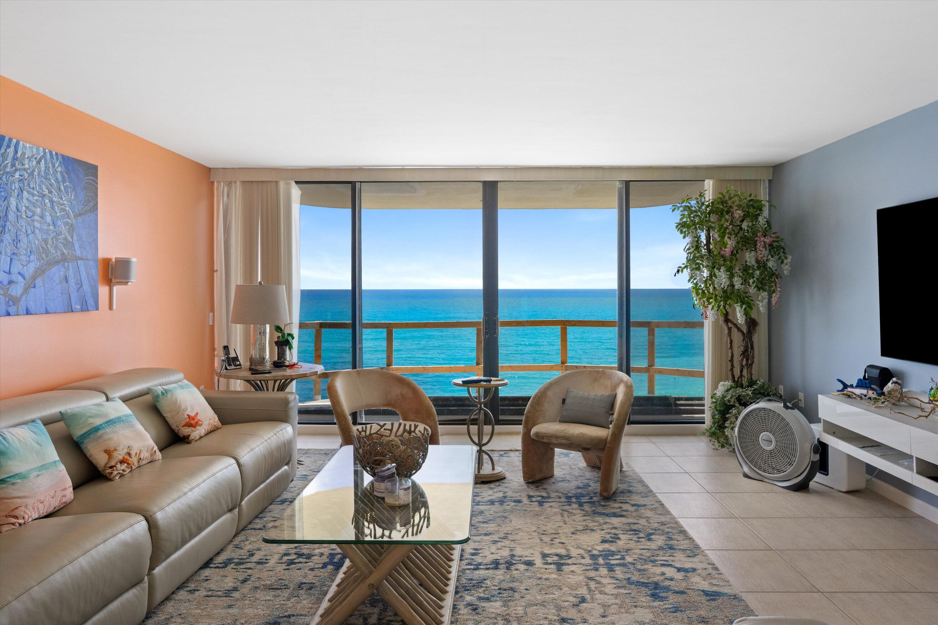 100 South Beach Road, Unit 702 Jupiter, FL 33469 - Photo 8 of 36 a living room with furniture a flat screen tv and a large window