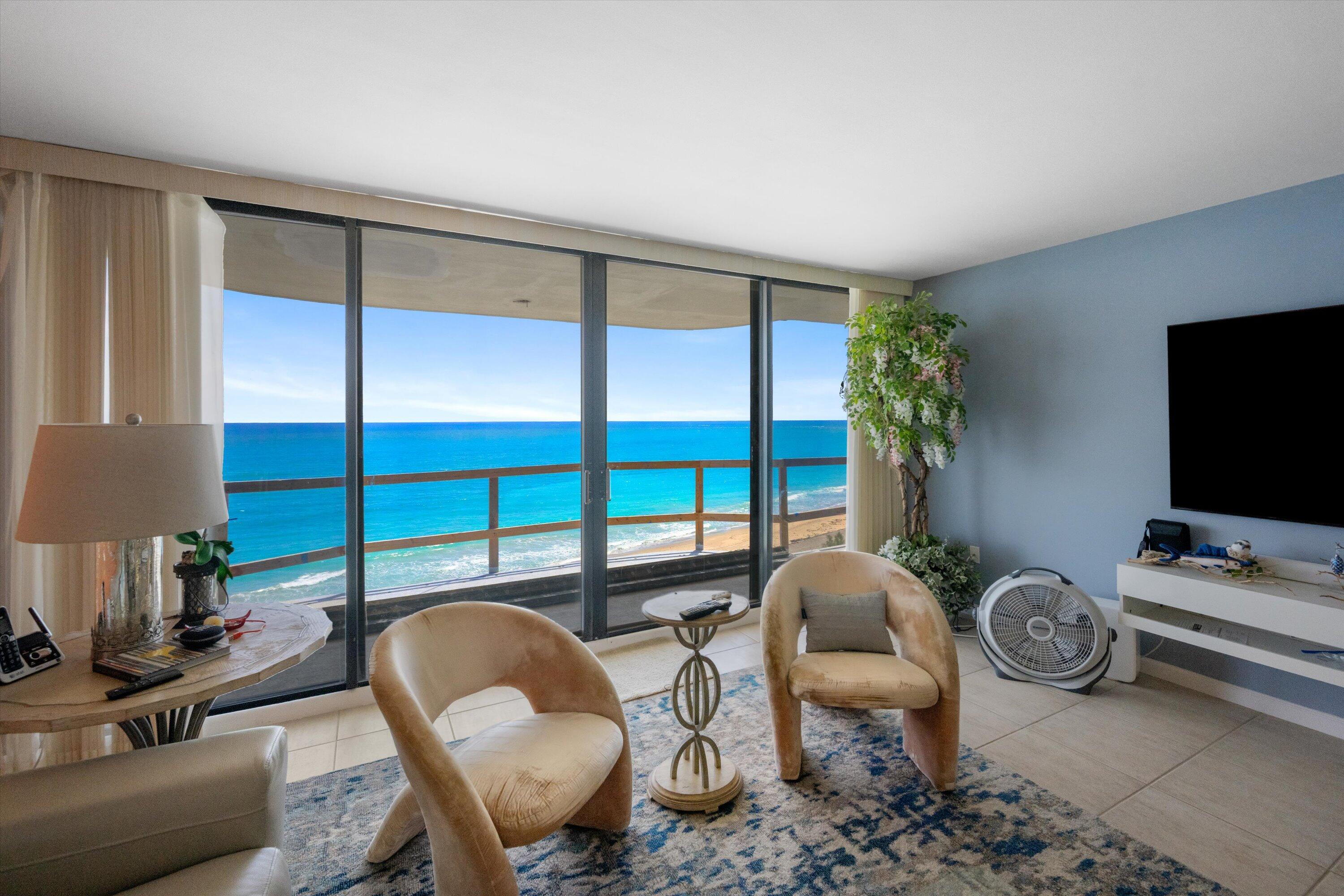 100 South Beach Road, Unit 702 Jupiter, FL 33469 - Photo 10 of 36 a living room with furniture a flat screen tv and a large window
