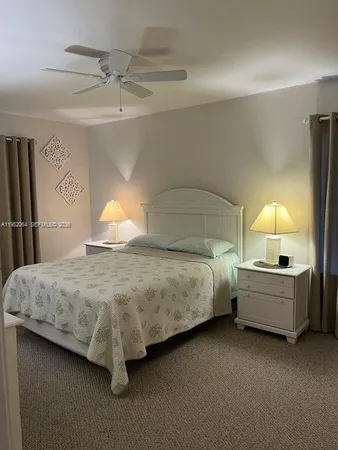 a bedroom with bed and window