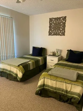 a bedroom with two beds and a couch