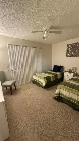 a bedroom with bed and a couch