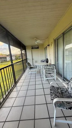a view of a chairs and table in the balcony