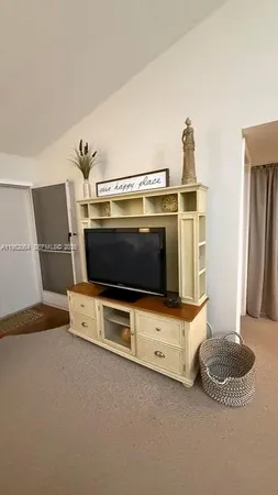 a living room with furniture and flat screen tv