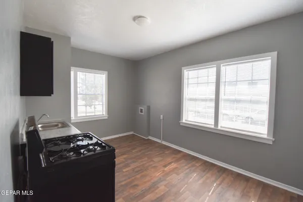 a kitchen with granite countertop a stove and a window