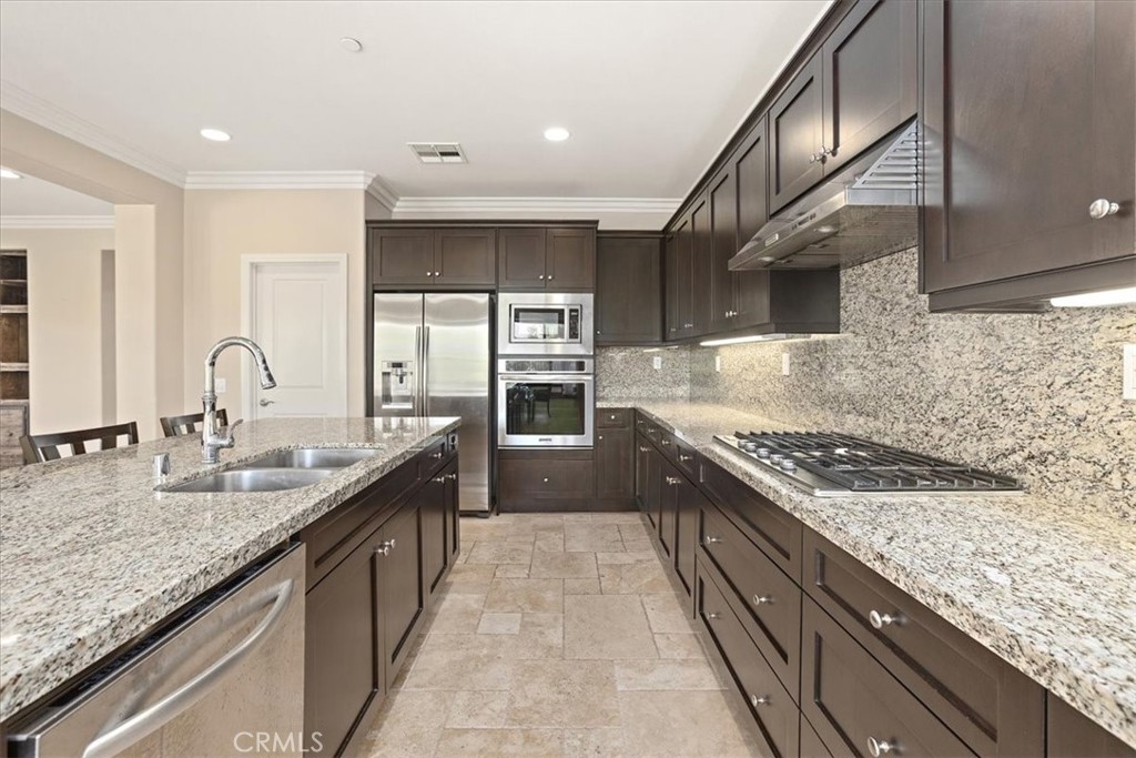 3152 Vista Terrace Riverside, CA 92503 - Photo 15 of 55 a large kitchen with granite countertop a sink and a stove
