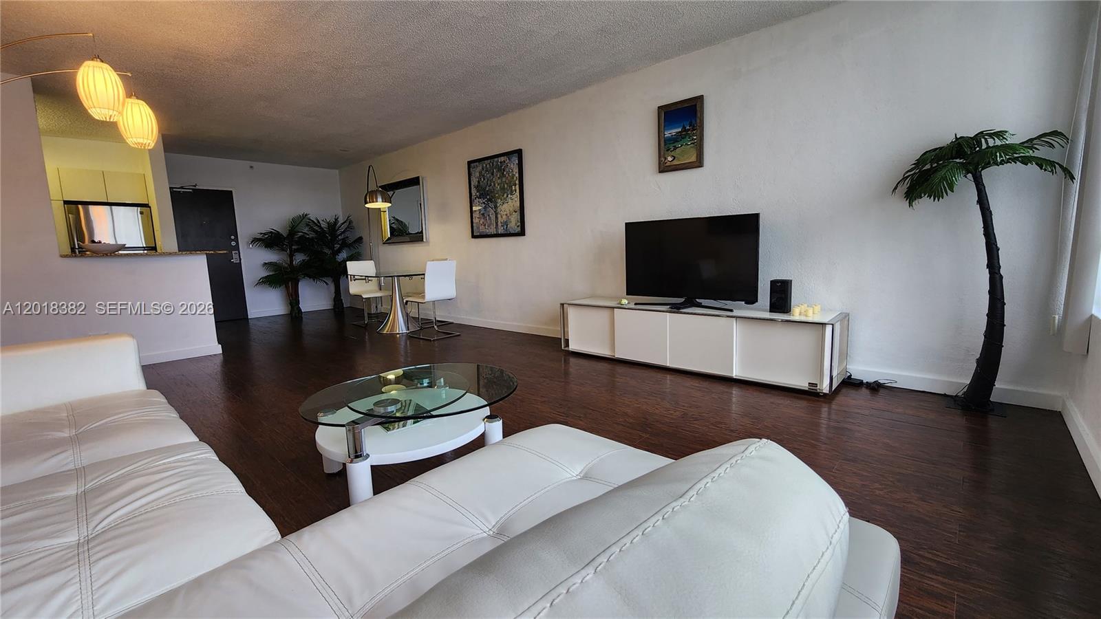 1500 Bay Road, Unit 1550S Miami Beach, FL 33139 - Photo 2 of 16 a living room with furniture and a flat screen tv