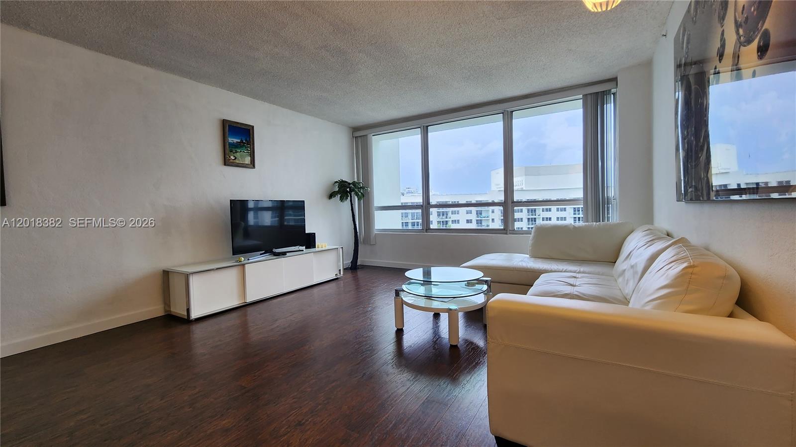 1500 Bay Road, Unit 1550S Miami Beach, FL 33139 - Photo 3 of 16 a living room with furniture and a flat screen tv