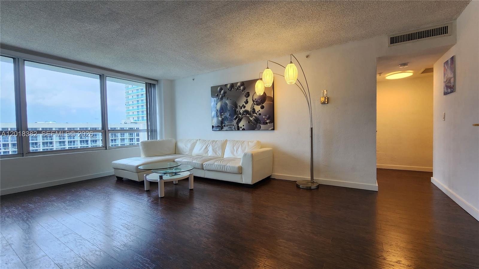 1500 Bay Road, Unit 1550S Miami Beach, FL 33139 - Photo 4 of 16 a living room with furniture and a wooden floor