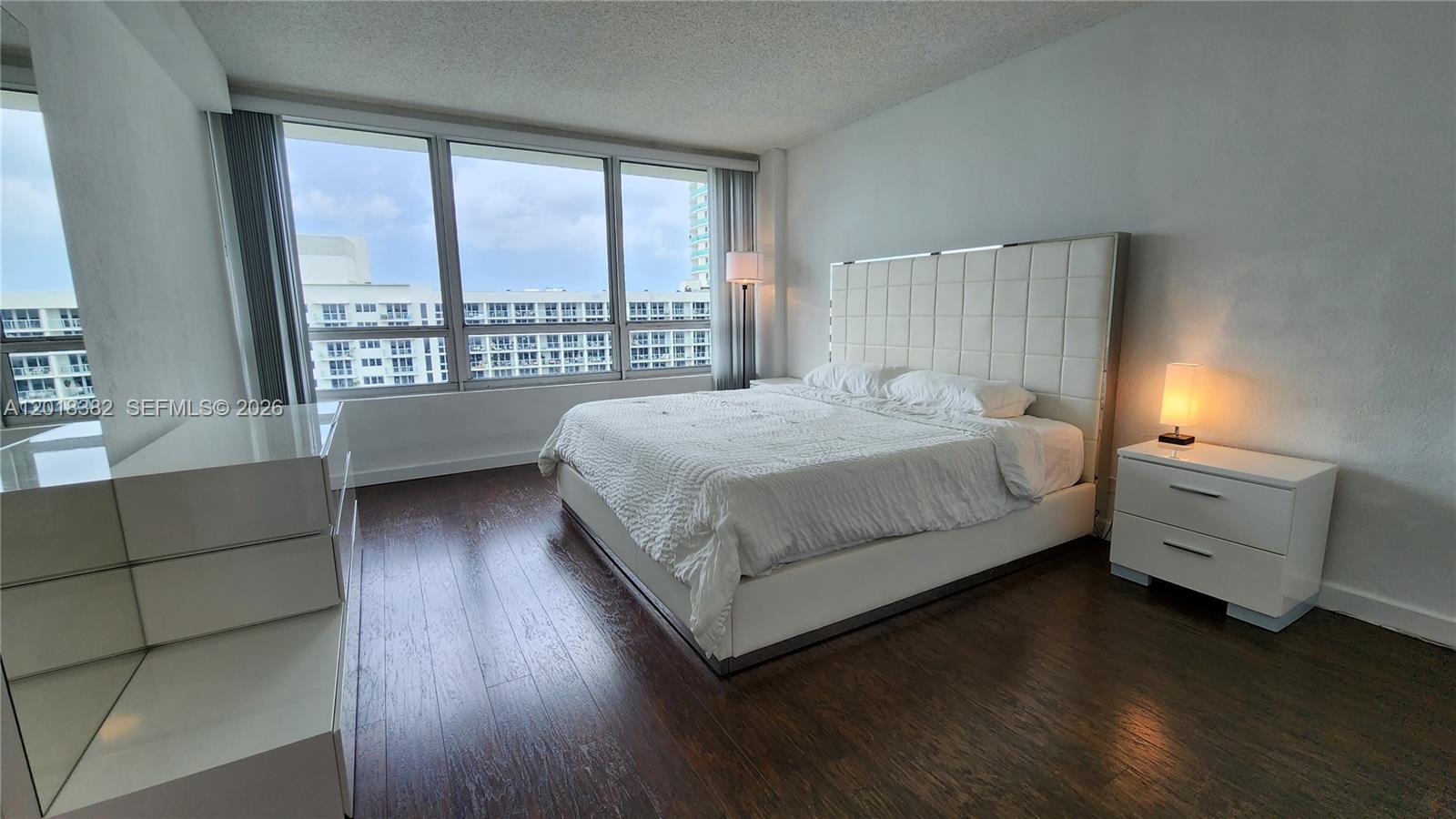 1500 Bay Road, Unit 1550S Miami Beach, FL 33139 - Photo 5 of 16 a bedroom with a bed and a large window