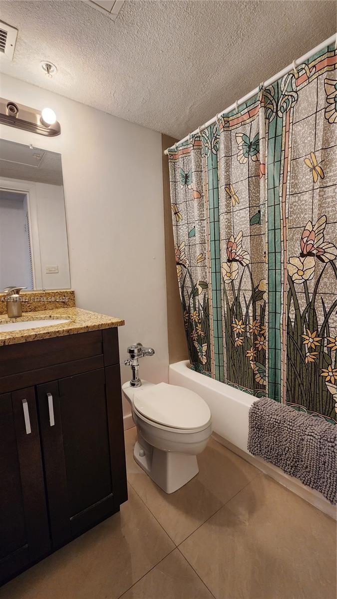 1500 Bay Road, Unit 1550S Miami Beach, FL 33139 - Photo 10 of 16 a bathroom with a granite countertop bathtub sink vanity mirror and toilet