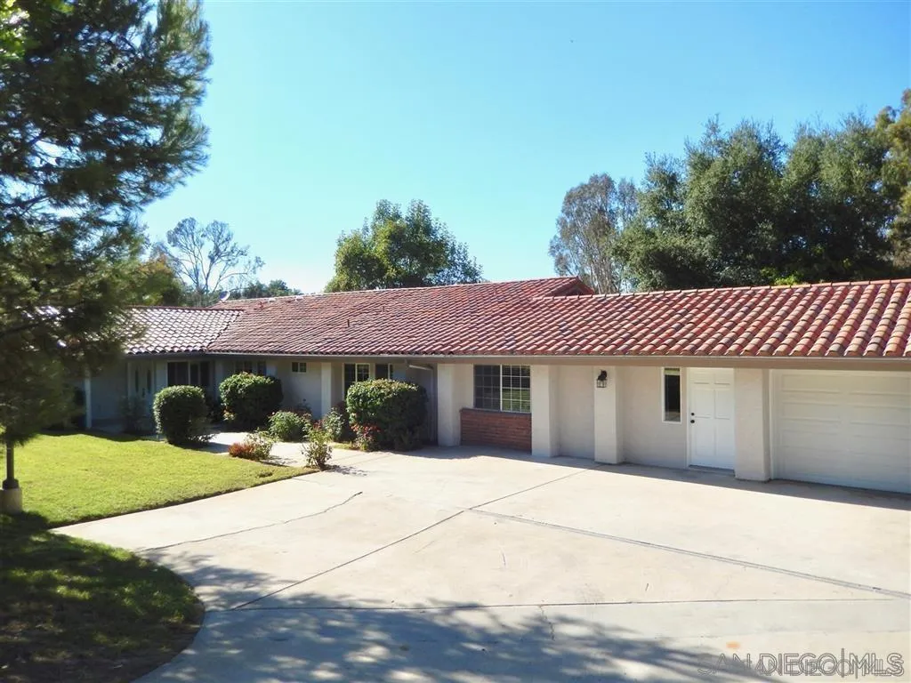 4959 Sleeping Indian Road Fallbrook, CA 92028 - Photo 1 of 22 a view of a white house with a yard