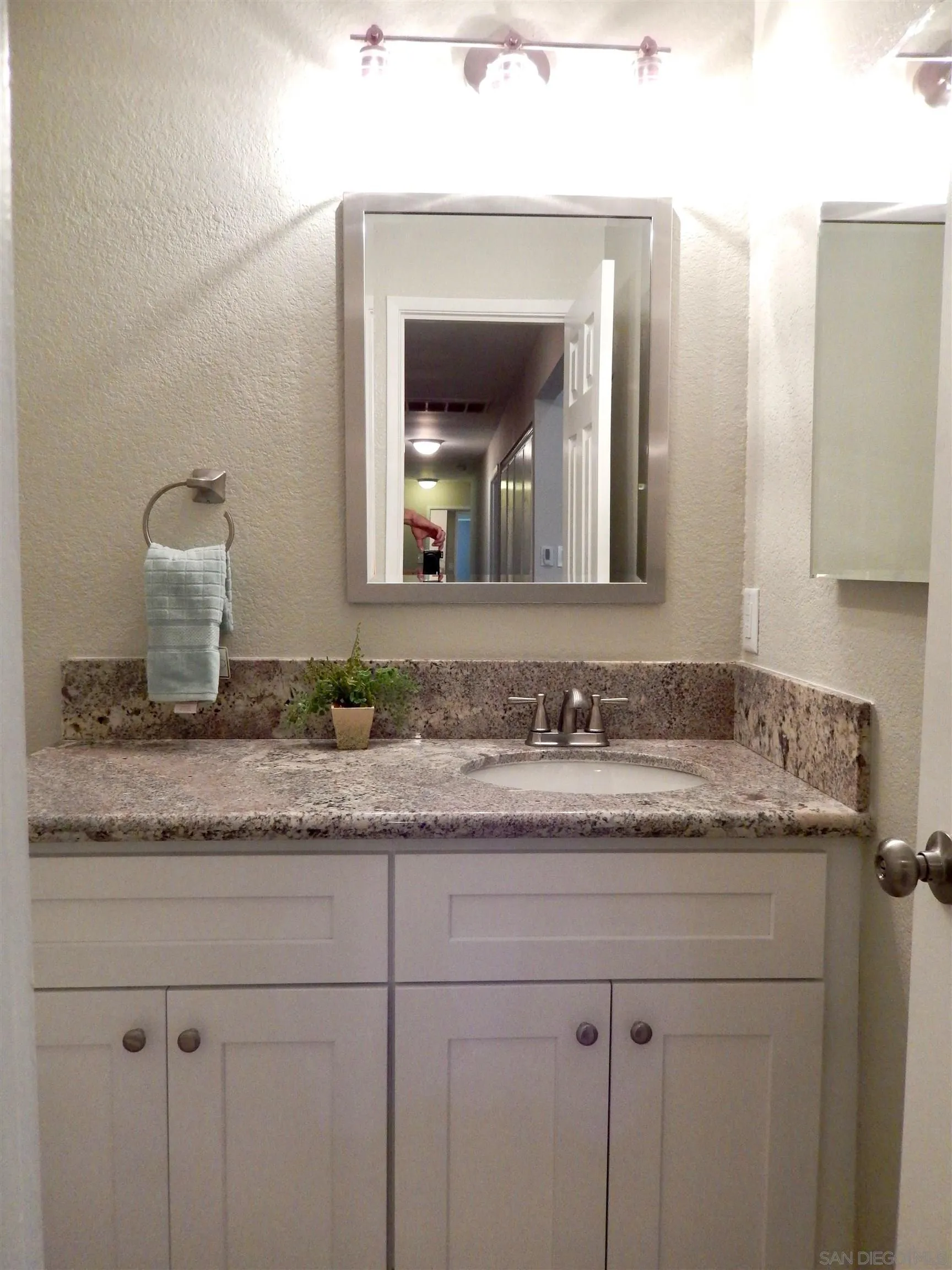 4959 Sleeping Indian Road Fallbrook, CA 92028 - Photo 15 of 22 a bathroom with a granite countertop sink vanity and mirror
