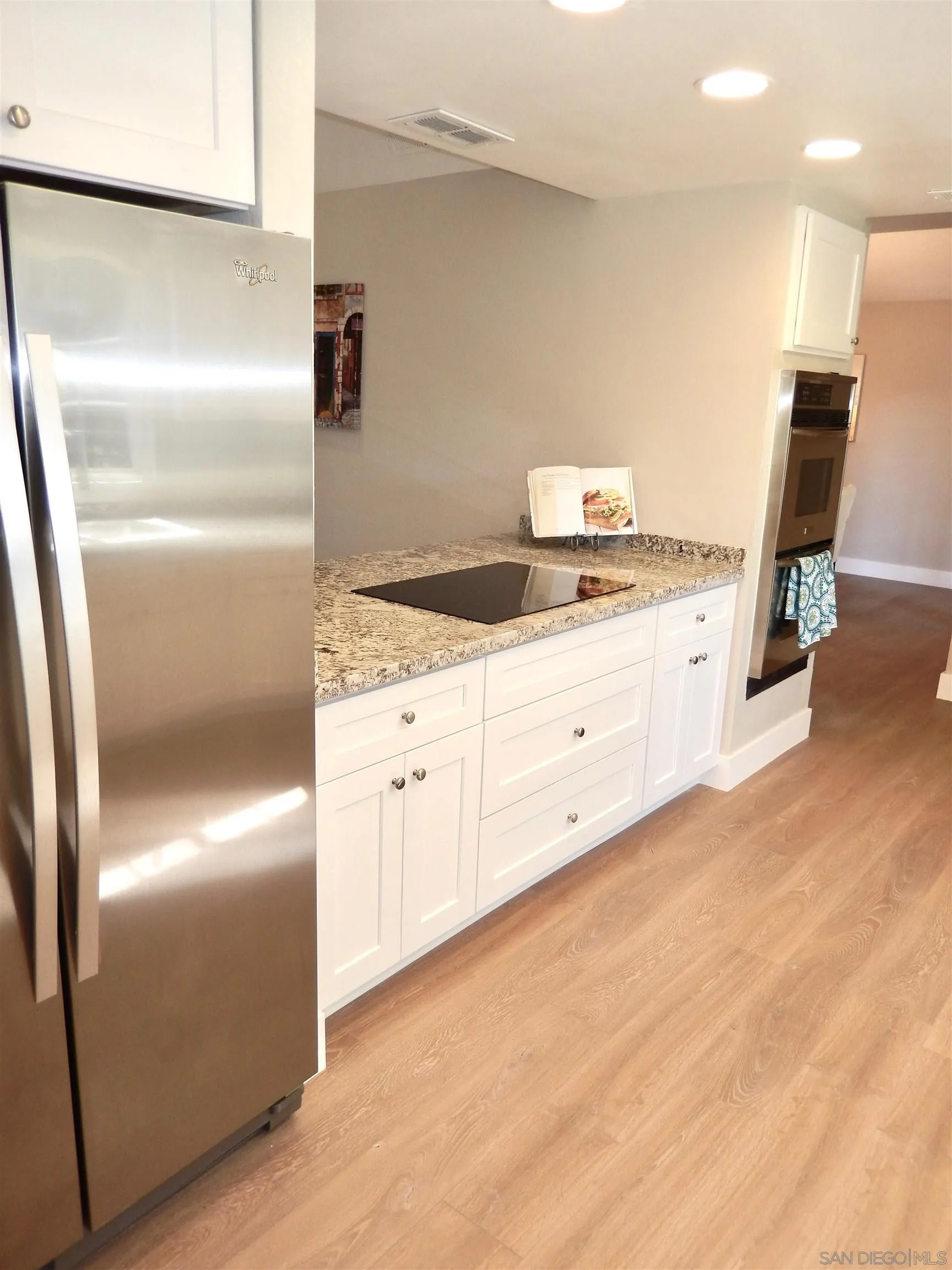 4959 Sleeping Indian Road Fallbrook, CA 92028 - Photo 17 of 22 a kitchen with granite countertop white cabinets and refrigerator